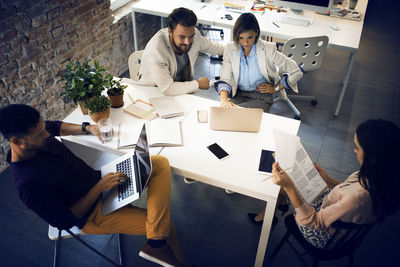 Business people working at table in office