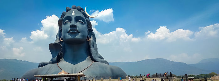 Low angle view of statue against cloudy sky