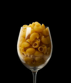 Close-up of drink in glass against black background