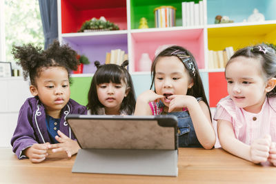 Children using digital tablet at preschool classroom