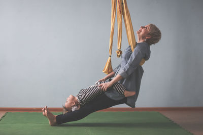 Low section of woman exercising at home