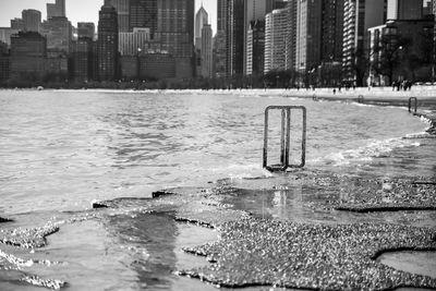 Buildings by wet city during winter