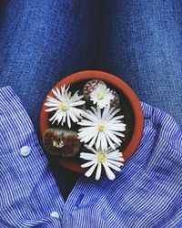 Low section of person with blue flower