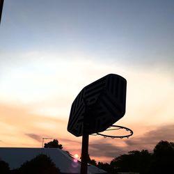 Low angle view of basketball hoop against sky during sunset