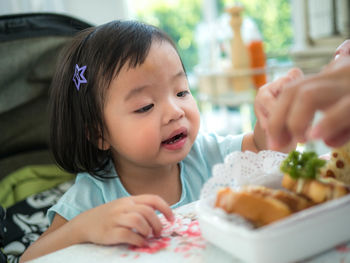 Portrait of cute girl having food