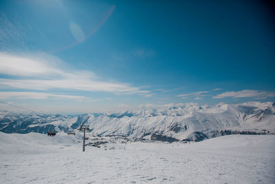 Aerial view of snow covered mountain range against sky