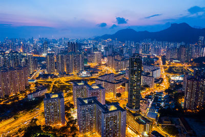 High angle view of illuminated buildings in city at night