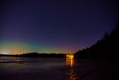 Scenic view of lake against sky at night