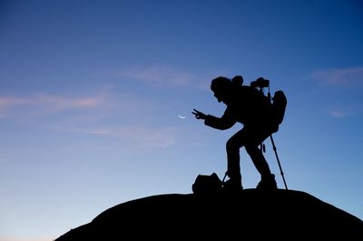 Low angle view of silhouette people against clear sky