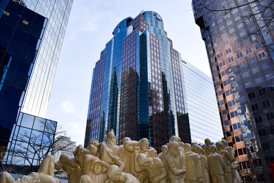 Low angle view of modern buildings against sky in city