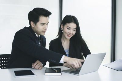 Young woman using laptop on table