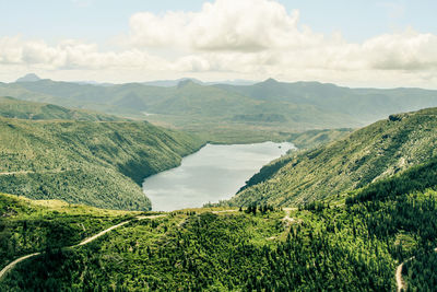 Scenic view of mountains against cloudy sky