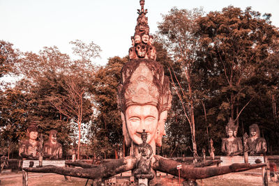 Statue of buddha against trees