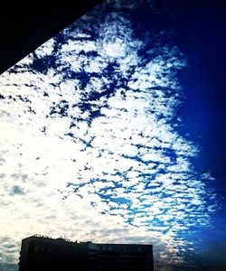 Low angle view of building against cloudy sky