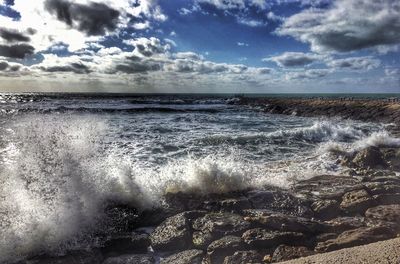 Scenic view of sea against cloudy sky