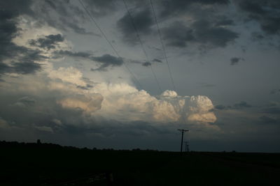 Low angle view of silhouette field against sky at sunset