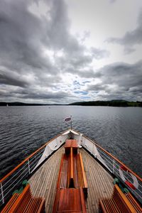 Boat sailing on sea against sky