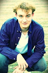 Portrait of young man sitting outdoors