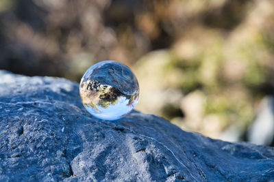 Close-up of crystal ball on rock