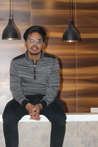 Portrait of young man sitting in sunglasses