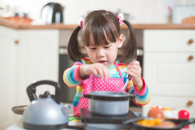 Cute girl preparing food at home