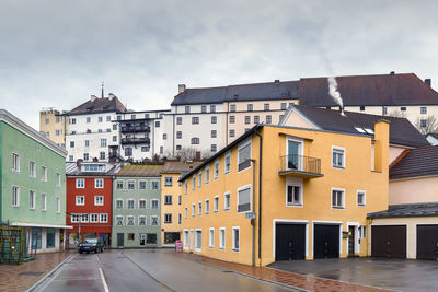 Residential buildings in city against sky