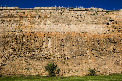 Rock formations on field against sky