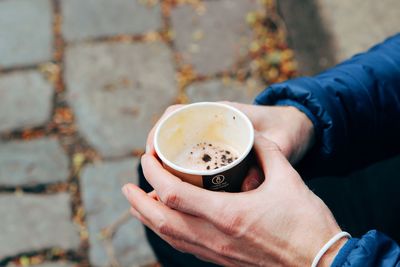 Midsection of woman holding coffee cup