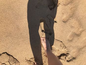 Shadow of person on sand