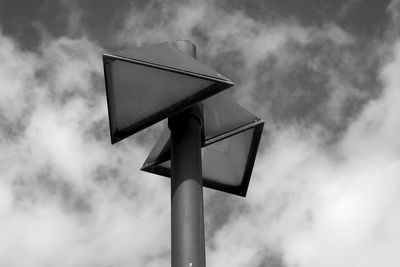 Low angle view of lighting equipment against cloudy sky