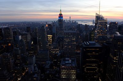 Aerial view of city lit up at sunset