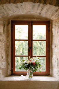 Flowers on window sill of house