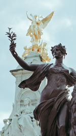 Low angle view of statue against sky