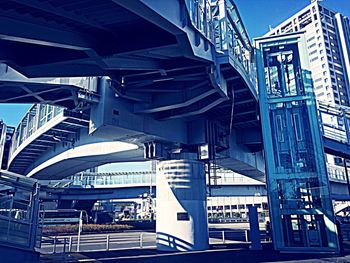 Low angle view of bridge against sky in city