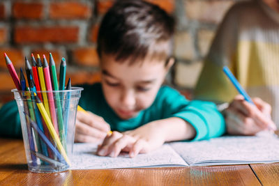 High angle view of boy with tattoo on table