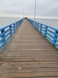 Pier over sea against sky