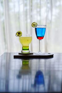 Drinks on table against window