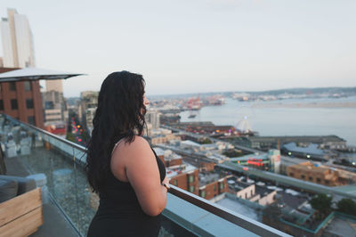 Rear view of woman standing in water