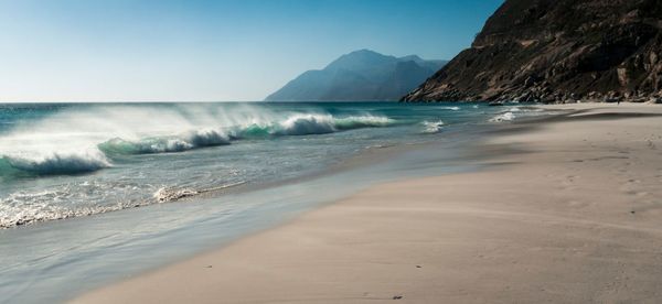 Scenic view of beach against clear sky