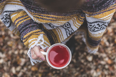 Cropped hand of woman holding coffee