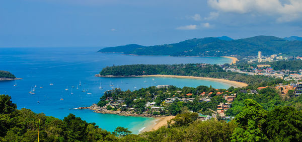 High angle view of cityscape by sea against sky