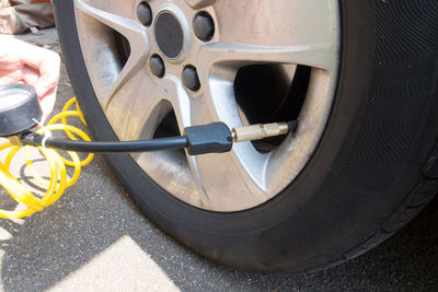 Close-up of man filling air in car