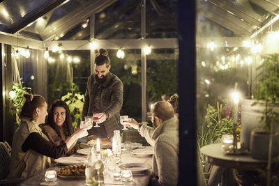 Friends having evening meal together