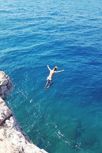 High angle view of bird flying over sea