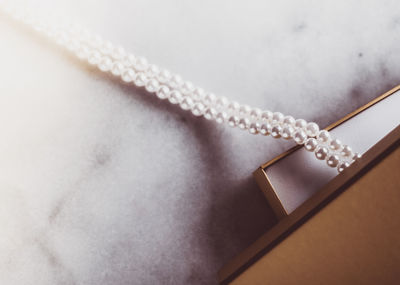 High angle view of pearl necklace on table