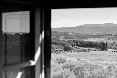 Scenic view of field seen through window