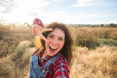 Portrait of happy woman on field