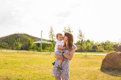 Happy mother and son on grass