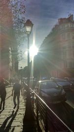 People walking on street during sunset