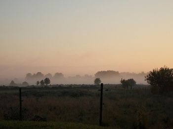 Scenic view of field against sky during sunset